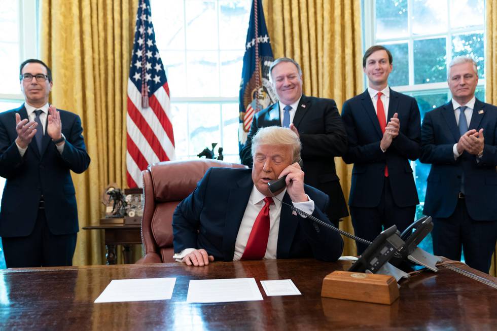 President Donald Trump talks on a phone call with the leaders of Sudan and Israel, as Treasury Secretary Steven Mnuchin, left, Secretary of State Mike Pompeo, White House senior adviser Jared Kushner, and National Security Adviser Robert O'Brien, applaud in the Oval Office of the White House, Friday, Oct. 23, 2020, in Washington. (AP Photo/Alex Brandon)