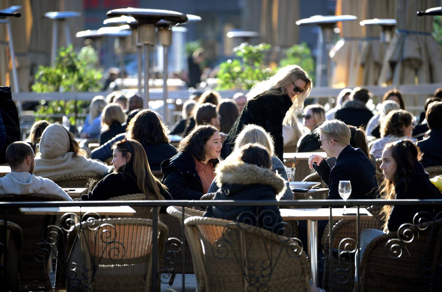 People enjoy the sun at an outdoor restaurant, despite the continuing spread of coronavirus disease (COVID-19), in Stockholm, Sweden March 26, 2020. TT News Agency/Janerik Henriksson via REUTERS      ATTENTION EDITORS - THIS IMAGE WAS PROVIDED BY A THIRD PARTY. SWEDEN OUT. NO COMMERCIAL OR EDITORIAL SALES IN SWEDEN.