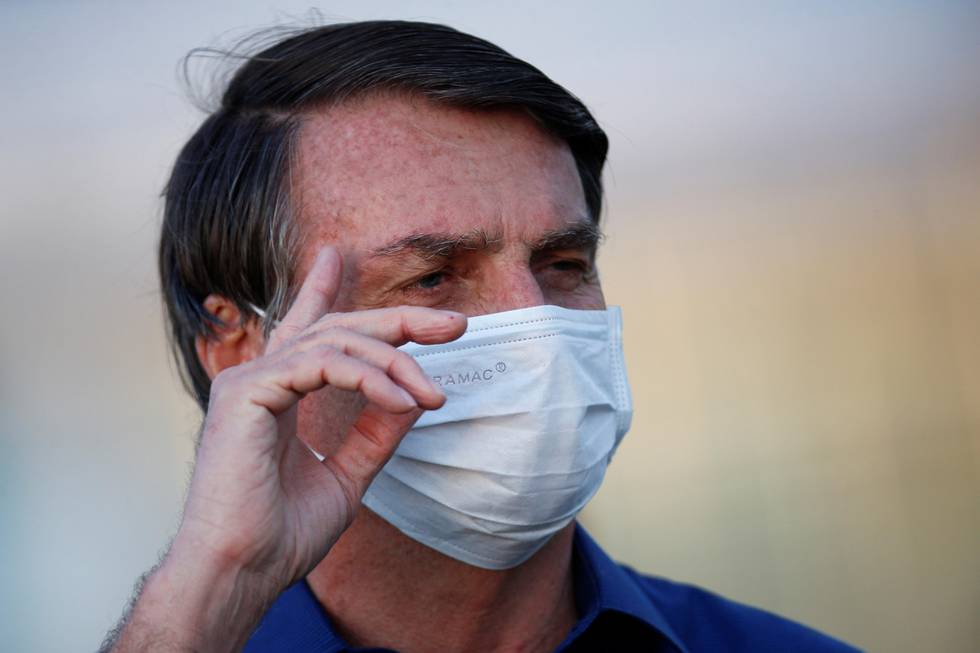 Brazil's President Jair Bolsonaro gestures during a ceremony of lowering the national flag for the night, amid the coronavirus disease (COVID-19) outbreak, at the Alvorada Palace in Brasilia, Brazil, July 18, 2020. REUTERS/Adriano Machado