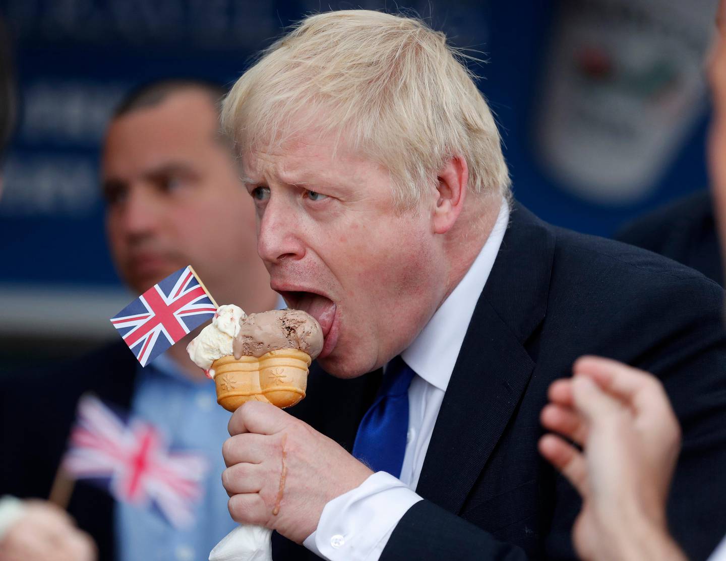 Conservative Party leadership candidate Boris Johnson eats an ice cream in Barry Island, Wales, Saturday, July 6, 2019 ahead of the Conservative party leadership hustings in Cardiff. The two contenders, Jeremy Hunt and Boris Johnson are competing for votes from party members, with the winner replacing Prime Minister Theresa May as party leader and Prime Minister of Britain's ruling Conservative Party. (AP Photo/Frank Augstein, Pool)