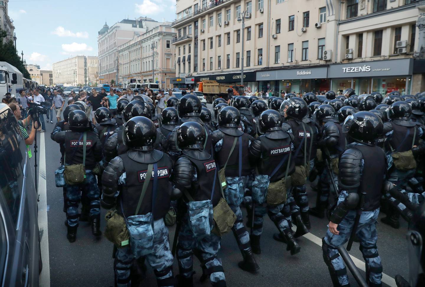 Police block a street during an unsanctioned rally in the center of Moscow, Russia, Saturday, July 27, 2019. Russian police are wrestling with demonstrators and have arrested hundreds in central Moscow during a protest demanding that opposition candidates be allowed to run for the Moscow city council. (AP Photo/ Pavel Golovkin)