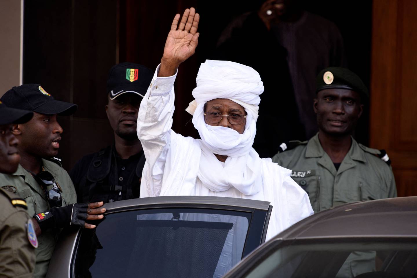 (FILES) In this file photo taken on June 03, 2015 Former Chadian President Hissene Habre gestures as he leaves a Dakar courthouse after an identity hearing. - Former Chadian President Hissène Habré has died at the age of 79 in Senegal, where he was sentenced to life imprisonment in 2016 for crimes against humanity after an unprecedented trial, Senegalese Justice Minister Malick Sall said on August 24, 2021. (Photo by SEYLLOU / AFP)