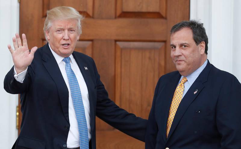 FILE - In this Nov. 20, 2016 file photo, then President-elect Donald Trump, left, waves to the media as New Jersey Gov. Chris Christie arrives at the Trump National Golf Club Bedminster clubhouse, in Bedminster, N.J. President Trump and his allies are harking back to his own transition four years ago to make a false argument that his own presidency was denied a fair chance for a clean launch. Trump fired the head of his transition, Chris Christie, and abandoned months of planning in favor of a Cabinet hiring process. His team also ignored offers of help from the outgoing Obama administration. (AP Photo/Carolyn Kaster, File)