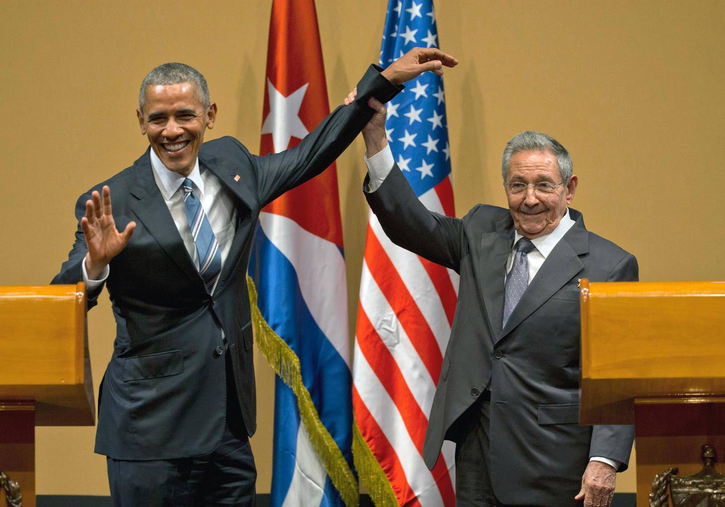 FILE - In this March 21, 2016 file photo, Cuban President Raul Castro, right, lifts up the arm of U.S. President Barack Obama, at the conclusion of their joint news conference at the Palace of the Revolution, in Havana, Cuba. Obama was joined by wife Michelle Obama and daughters Malia and Sasha in the first visit by a sitting U.S. president to the island nation in 88 years. (AP Photo/Ramon Espinosa, File)