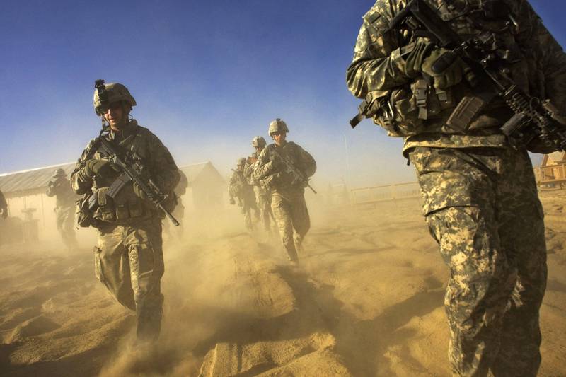 (FILES) In this file photo taken on November 28, 2008, US Army soliders from 1-506 Infantry Division set out on a patrol in Paktika province, situated along the Afghan-Pakistan border. - The US military is proceeding with President Donald Trump's order to slash troops in Afghanistan to 2,500 by mid-January, the Pentagon's top general said on December 2, 2020, calling the situation on the ground a "strategic stalemate." Joint Chiefs Chairman General Mark Milley, who earlier appeared opposed to cuts on the estimated 4,500 US troops currently there, said the United States had been successful "to a large measure" at its original goal of hitting Al-Qaeda after the September 11, 2001 attacks. (Photo by DAVID FURST / AFP)