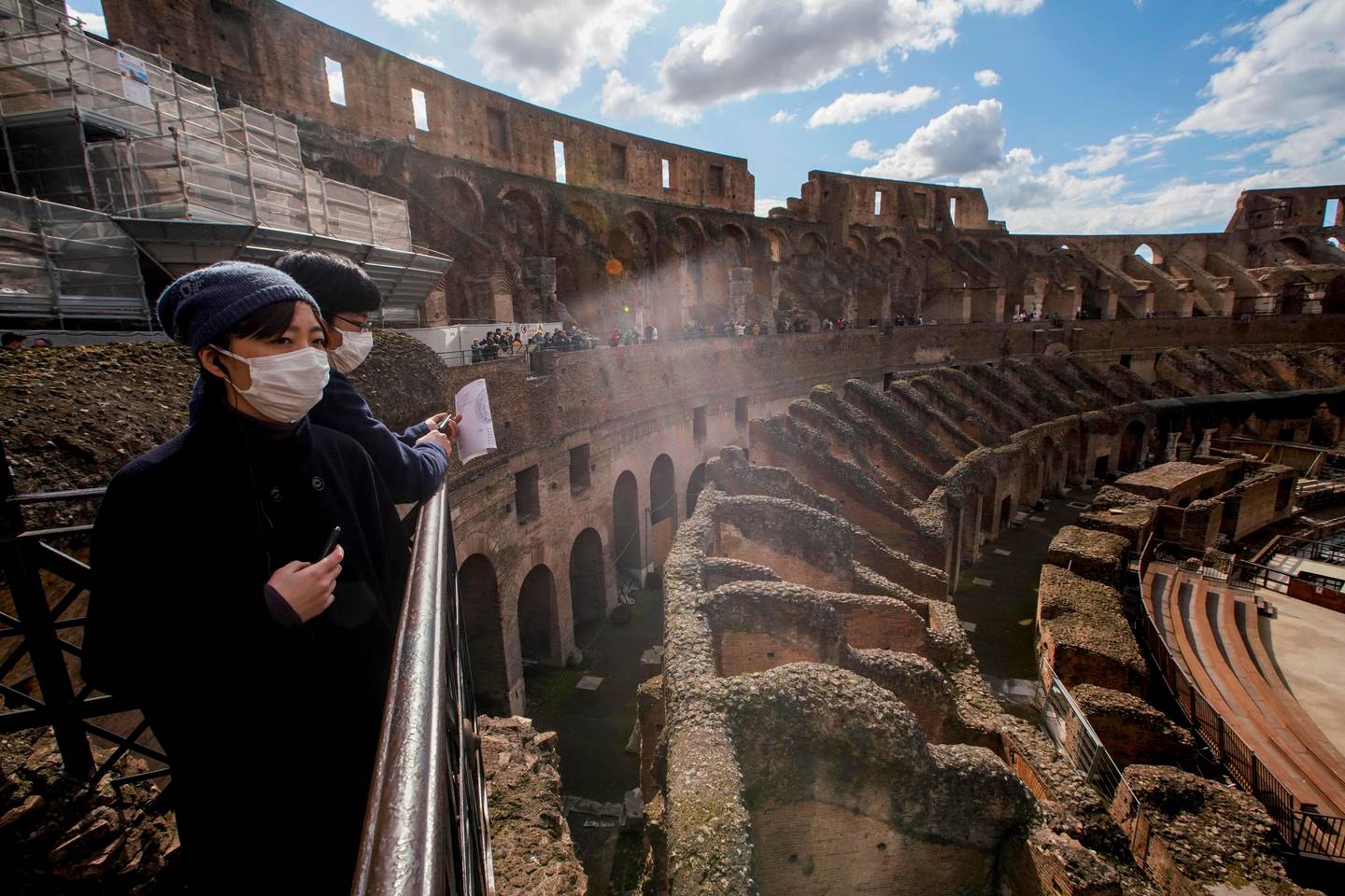 Tourists visit the Colosseum, in Rome, Saturday, March 7, 2020. With the coronavirus emergency deepening in Europe, Italy, a focal point in the contagion, risks falling back into recession as foreign tourists are spooked from visiting its cultural treasures and the global market shrinks for prized artisanal products, from fashion to design. (AP Photo/Andrew Medichini)