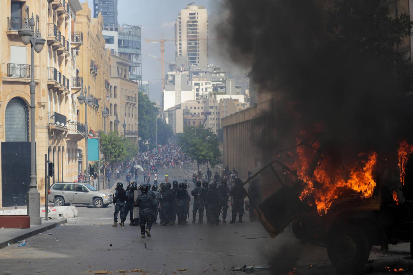 People clash with police during a protest against the political elites and the government after this week's deadly explosion at Beirut port which devastated large parts of the capital and killed more than 150 people, in Beirut, Lebanon, Saturday, Aug. 8, 2020. (AP Photo/Hassan Ammar)