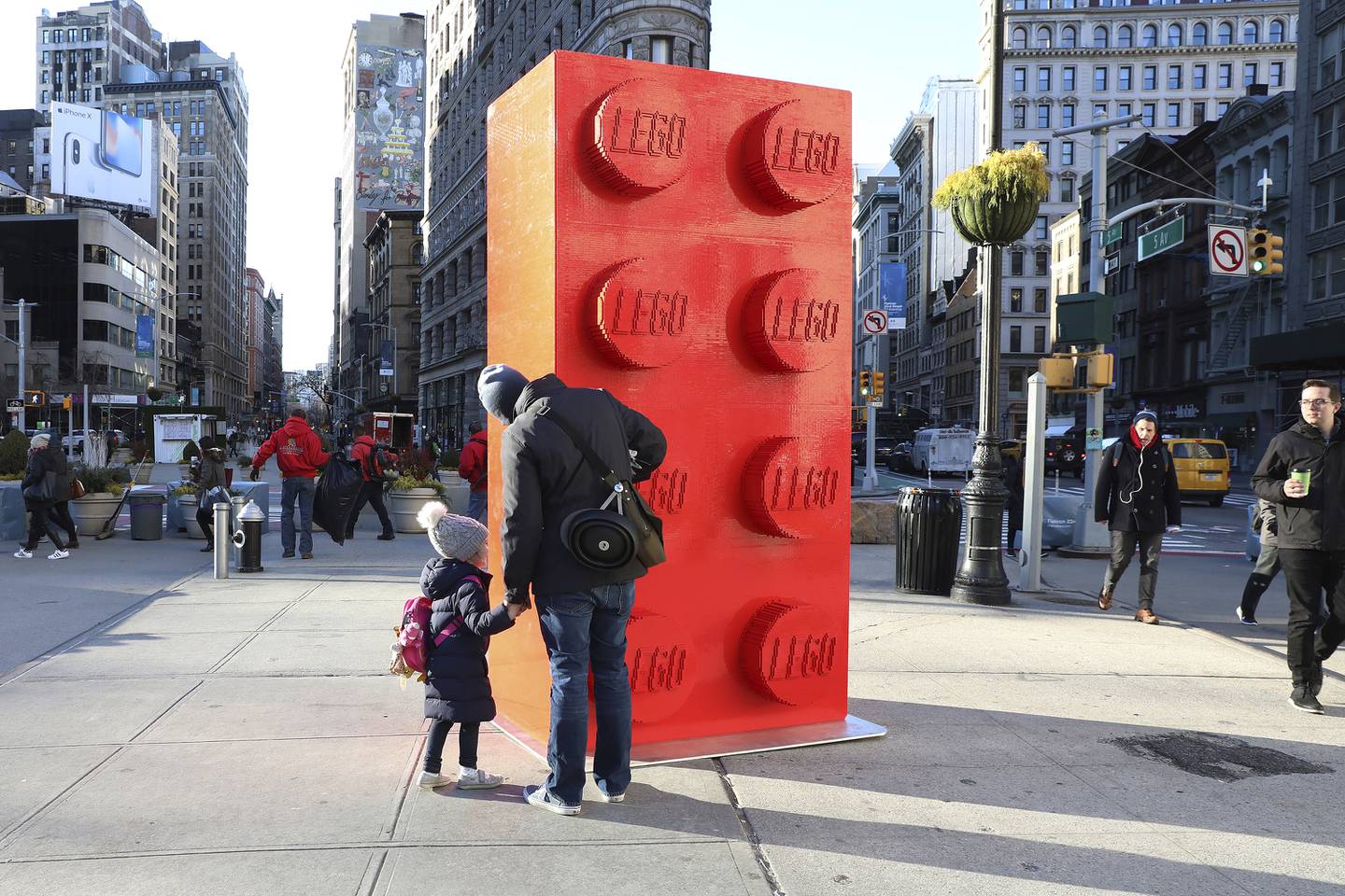 IMAGE DISTRIBUTED FOR THE LEGO GROUP - A young New Yorker stands in front of a LEGO brick model at a temporary installation celebrating the iconic brick's 60th birthday in New York's Flatiron Plaza, on Friday, January 26, 2018. (Amy Sussman/AP Images for The LEGO Group)