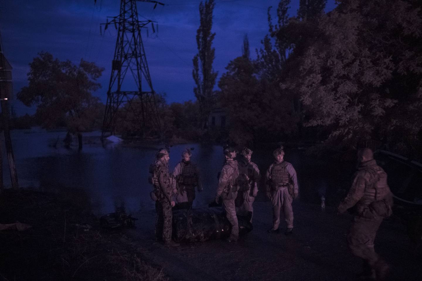 Ukraine Special Operations Forces soldiers prepare for a night mission on the Dnipro River in Kherson region, Ukraine, Sunday, June 11, 2023. (AP Photo/Felipe Dana)