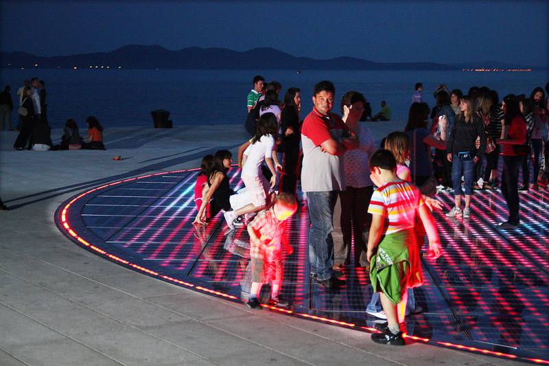 Om kvelden samles store og små for å høre bruset fra havorgelet og leke seg på kunstinstallasjonen «Solhilsen» på havnepromenaden i Zadar.