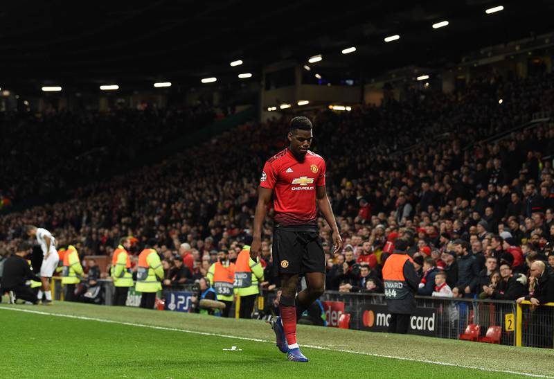 Manchester United's French midfielder Paul Pogba leaves the pitch after being shown a red card during the first leg of the UEFA Champions League round of 16 football match between Manchester United and Paris Saint-Germain (PSG) at Old Trafford in Manchester, north-west England on February 12, 2019. - PSG won the match 2-0. (Photo by Paul ELLIS / AFP)