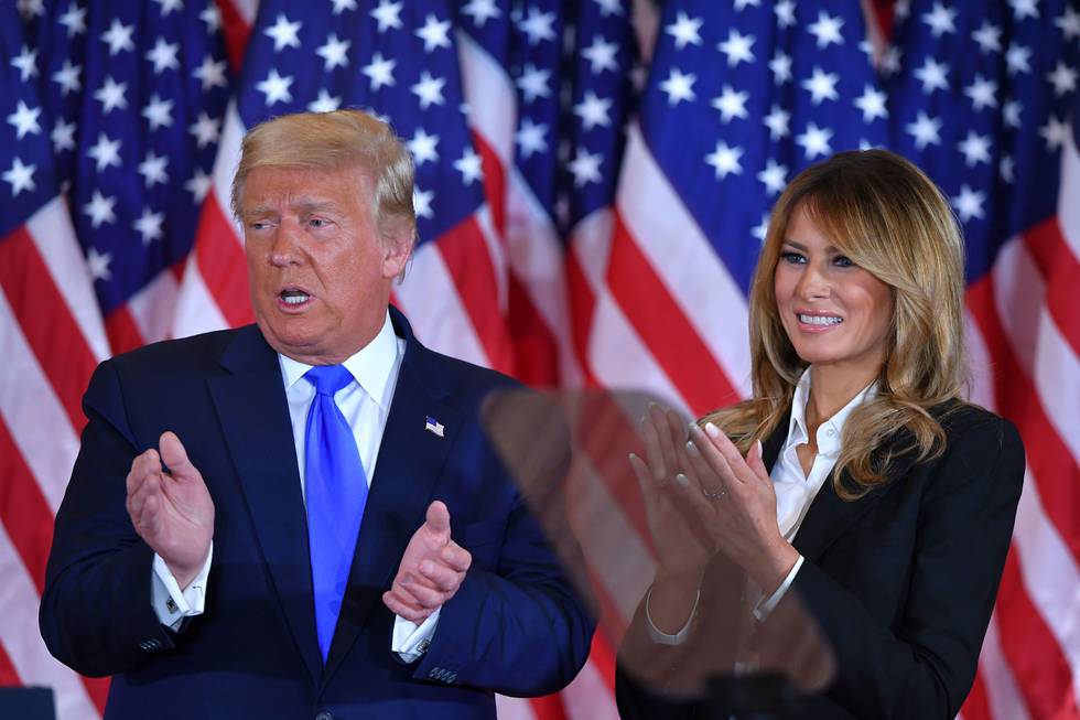 US President Donald Trump claps alongside US First Lady Melania Trump after speaking during election night in the East Room of the White House in Washington, DC, early on November 4, 2020. (Photo by MANDEL NGAN / AFP)