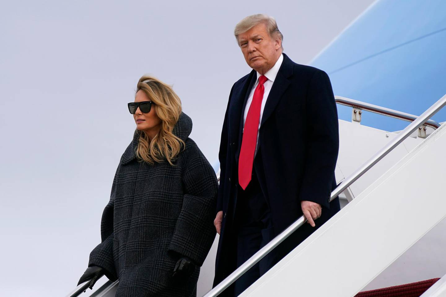 President Donald Trump and first lady Melania Trump step off Air Force One at Andrews Air Force Base, Md., Thursday, Dec. 31, 2020. Trump is returning to Washington after visiting his Mar-a-Lago resort. (AP Photo/Patrick Semansky)