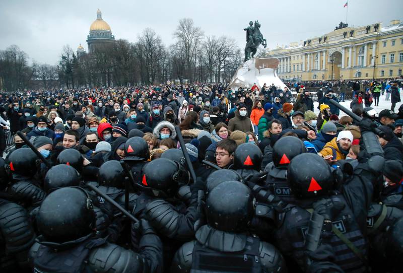 People clash with police during a protest against the jailing of opposition leader Alexei Navalny in St.Petersburg, Russia, Saturday, Jan. 23, 2021. Russian police on Saturday arrested hundreds of protesters who took to the streets in temperatures as low as minus-50 C (minus-58 F) to demand the release of Alexei Navalny, the country's top opposition figure. A Navalny, President Vladimir Putin's most prominent foe, was arrested on Jan. 17 when he returned to Moscow from Germany, where he had spent five months recovering from a severe nerve-agent poisoning that he blames on the Kremlin. (AP Photo/Dmitri Lovetsky)