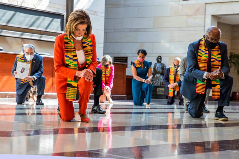 House Speaker Nancy Pelosi of Calif., center, and other members of Congress, kneel and observe a moment of silence at the Capitol's Emancipation Hall, Monday, June 8, 2020, on Capitol Hill in Washington, reading the names of George Floyd and others killed during police interactions. Democrats proposed a sweeping overhaul of police oversight and procedures Monday, an ambitious legislative response to the mass protests denouncing the deaths of black Americans at the hands of law enforcement.  (AP Photo/Manuel Balce Ceneta)