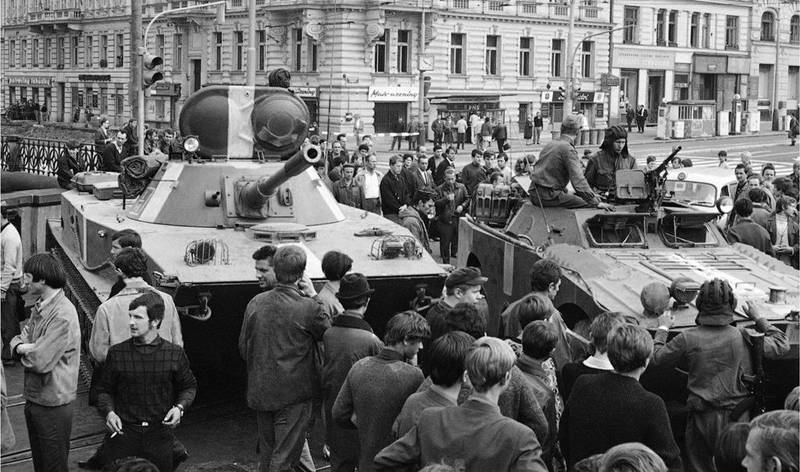 Image on top: FILE - In this Aug. 21, 1968 file photo, a Soviet tank and an armored personnel carrier move into downtown Prague as part of the occupation of the Czech capital and other parts of the country by troops of Russia, Poland, Hungary, Bulgaria and East Germany. (AP Photo, file) Image on bottom: In this picture taken on Thursday, Aug. 16, 2018 cars drive downtown Prague. On August 21, 2018 Czech Republic is commemorating the 50th anniversary of the Soviet-led invasion in Czechoslovakia in 1968. (AP Photo/Petr David Josek)