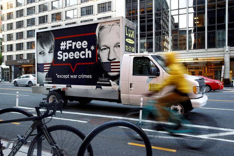 A vehicle with a "Free Speech" placard and images of Chelsea Manning and WikiLeaks founder Julian Assange sits across the street from a building hosting an event with Ecuador's President Lenin Moreno, Tuesday, April 16, 2019, at the Inter-American Dialogue think tank in Washington. Police arrested Assange at Ecuador's embassy in London on April 11, 2019. (AP Photo/Patrick Semansky)