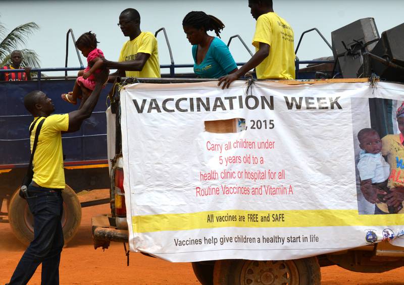 VAKSINERES: Familier ankommer et vaksinasjonssenter i et fattig område i Monrovia. Mangel på vaksinering under ebolakrisen har gjort barn der sårbare for nok en trussel: meslinger. FOTO: ZOOM DOSSO/NTB SCANPIX