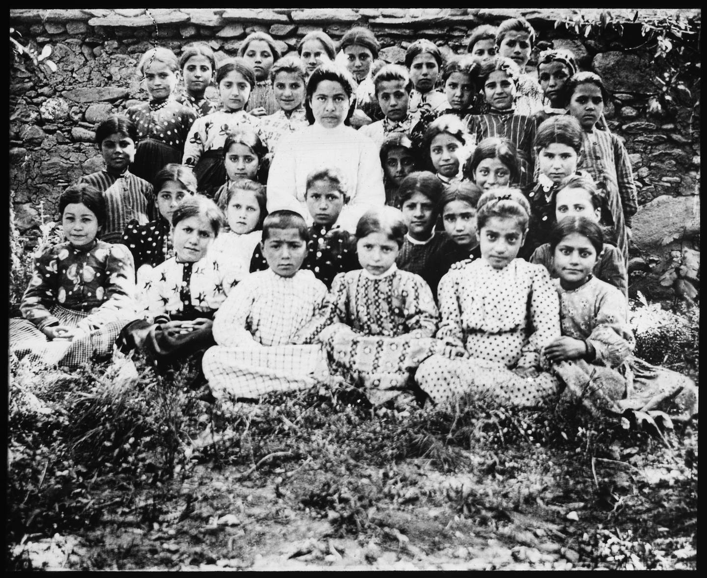 «En av klassene i fagskolen i Musch med lærerinnen Margarit. Hadde i flere år en fagskole i Musch. De fleste av de 120 barn i fagskolen blev myrdet i 1915.