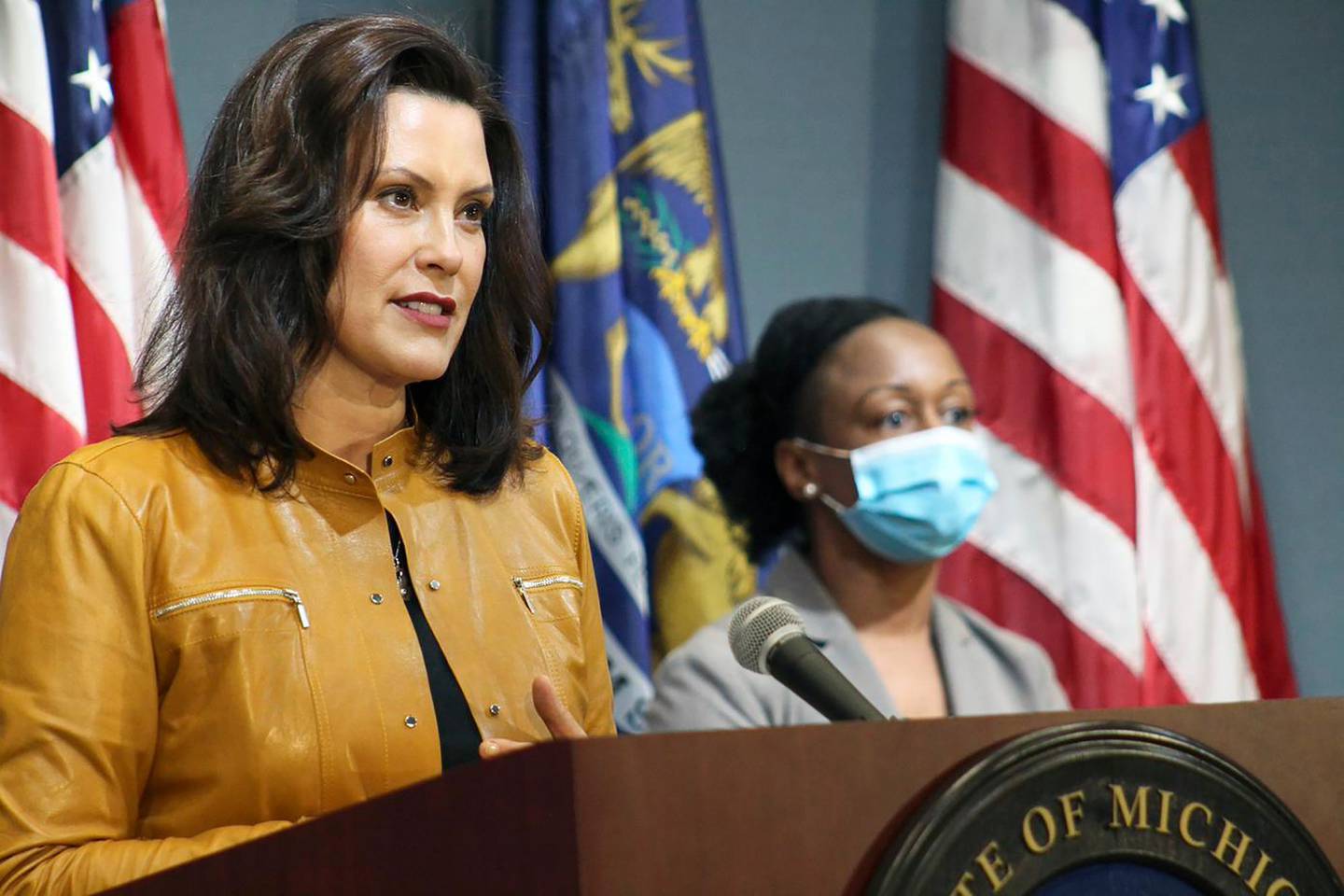 In this photo provided by the Michigan Office of the Governor, Michigan Gov. Gretchen Whitmer addresses the state during a speech in Lansing, Mich., Thursday, May 7, 2020. Whitmer said that auto and other manufacturing workers can return to the job next week, further easing her stay-at-home order while extending it through May 28 because of the coronavirus pandemic. (Michigan Office of the Governor via AP, Pool)
