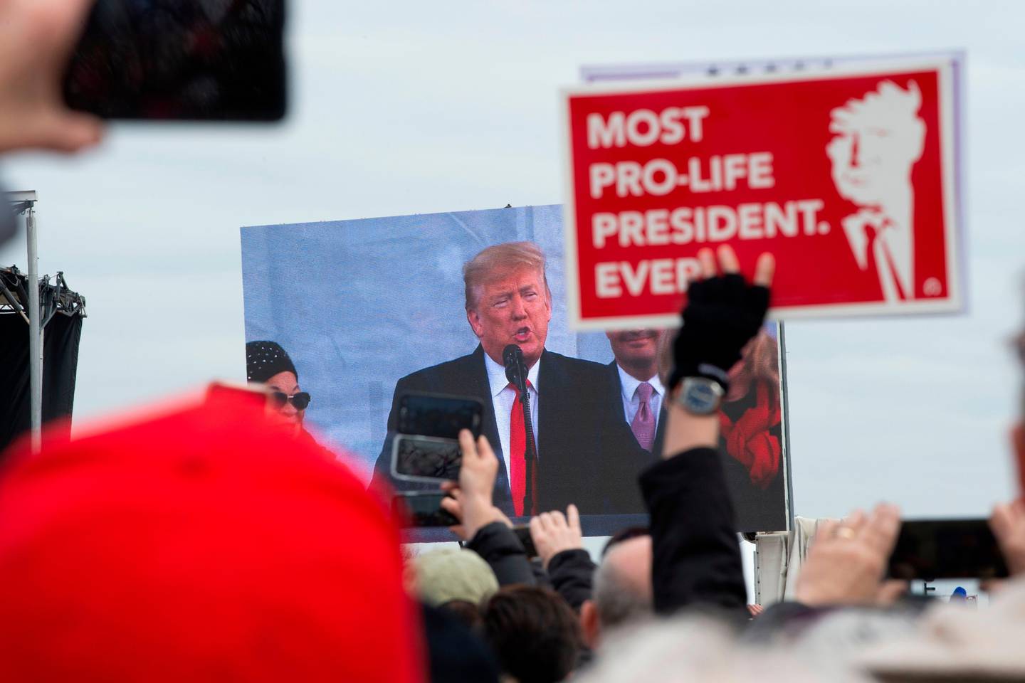 Pro-life demonstrators listen to US President Donald Trump as he speaks at the 47th annual "March for Life" in Washington, DC, on January 24, 2020. - Trump is the first US president to address in person the country's biggest annual gathering of anti-abortion campaigners. (Photo by Roberto SCHMIDT / AFP)