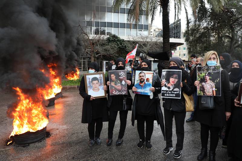 Relatives of victims of Beirut port explosion stand near burning tires during a protest, after a Lebanese court removed the judge leading the investigation into the explosion, outside the Justice Palace in Beirut, Lebanon February 19, 2021. REUTERS/Mohamed Azakir