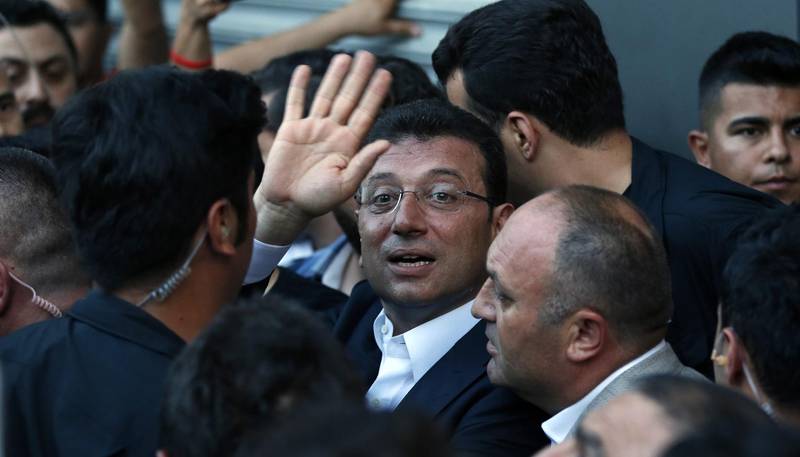 Newly elected mayor of Istanbul Ekrem Imamoglu waves to his supporters outside the Republican People's Party, CHP, offices in Istanbul, Sunday, June 23, 2019. Turkish President Recep Tayyip Erdogan has congratulated the opposition candidate who won a repeat mayoral election in Istanbul and defeated Erdogan's candidate for the second time. (AP Photo/Lefteris Pitarakis)