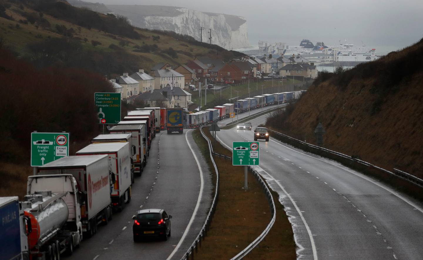 FILE - In this Friday, Dec. 11, 2020 file photo lorries queue on the approach to Dover, England. Britain and the European Union have struck a provisional free-trade agreement that should avert New Year chaos for cross-border traders and bring a measure of certainty for businesses after years of Brexit turmoil.  (AP Photo/Frank Augstein, File)