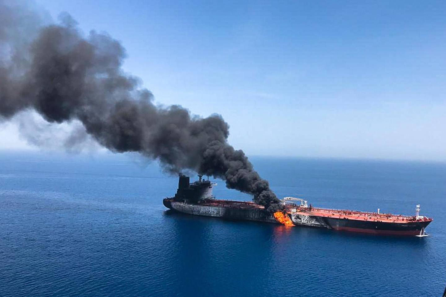 FILE - In this Thursday, June 13, 2019 file photo, an oil tanker is on fire in the sea of Oman. A series of attacks on oil tankers near the Persian Gulf has ratcheted up tensions between the U.S. and Iran -- and raised fears over the safety of one of AsiaÄôs most vital energy trade routes, where about a fifth of the worldÄôs oil passes through its narrowest at the Strait of Hormuz. The attacks have jolted the shipping industry, with many of operators in the region on high alert. (AP Photo/ISNA, File)
