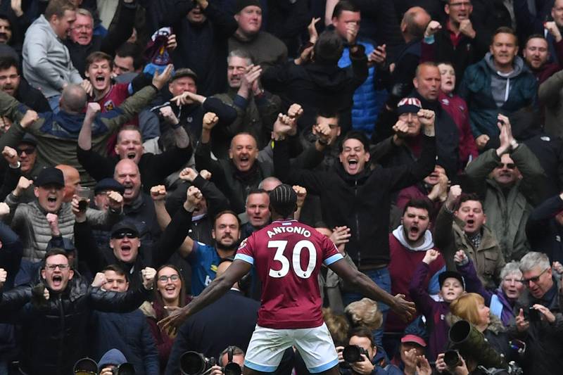 West Ham United's English midfielder Michail Antonio celebrates in front of the West Ham fans after scoring the opening goal of the English Premier League football match between Tottenham Hotspur and West Ham United at Tottenham Hotspur Stadium in London, on April 27, 2019. (Photo by Ben STANSALL / AFP) / RESTRICTED TO EDITORIAL USE. No use with unauthorized audio, video, data, fixture lists, club/league logos or 'live' services. Online in-match use limited to 120 images. An additional 40 images may be used in extra time. No video emulation. Social media in-match use limited to 120 images. An additional 40 images may be used in extra time. No use in betting publications, games or single club/league/player publications. / 