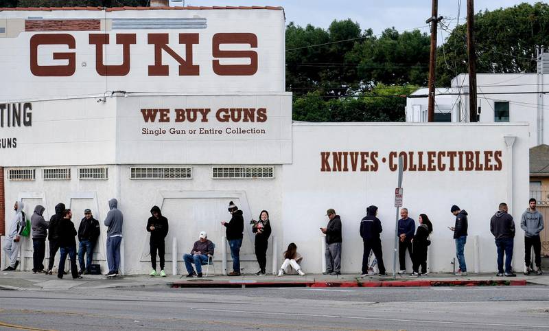 People wait in a line to enter a gun store in Culver City, Calif., March 15, 2020. (AP Photo/Ringo H.W. Chiu)