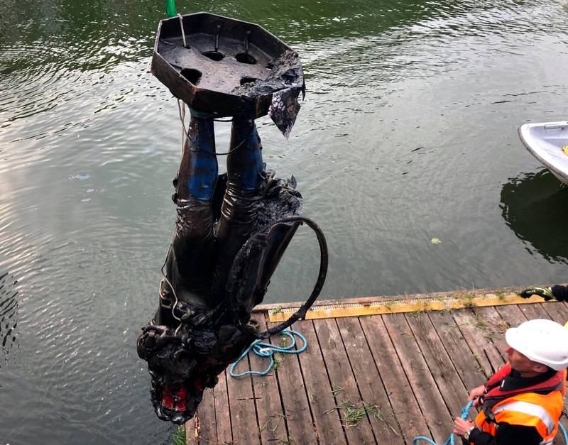 In this photograph made available by Bristol City Council, the statue of Edward Colston is recovered from the harbour in Bristol, Thursday June 11, 2020, after it was toppled by anti-racism protesters on Sunday. The council says it has been taken to a secure location and will end up in a museum. Colston built a fortune transporting enslaved Africans across the Atlantic, and left most of his money to charity. (Bristol City Council via AP)