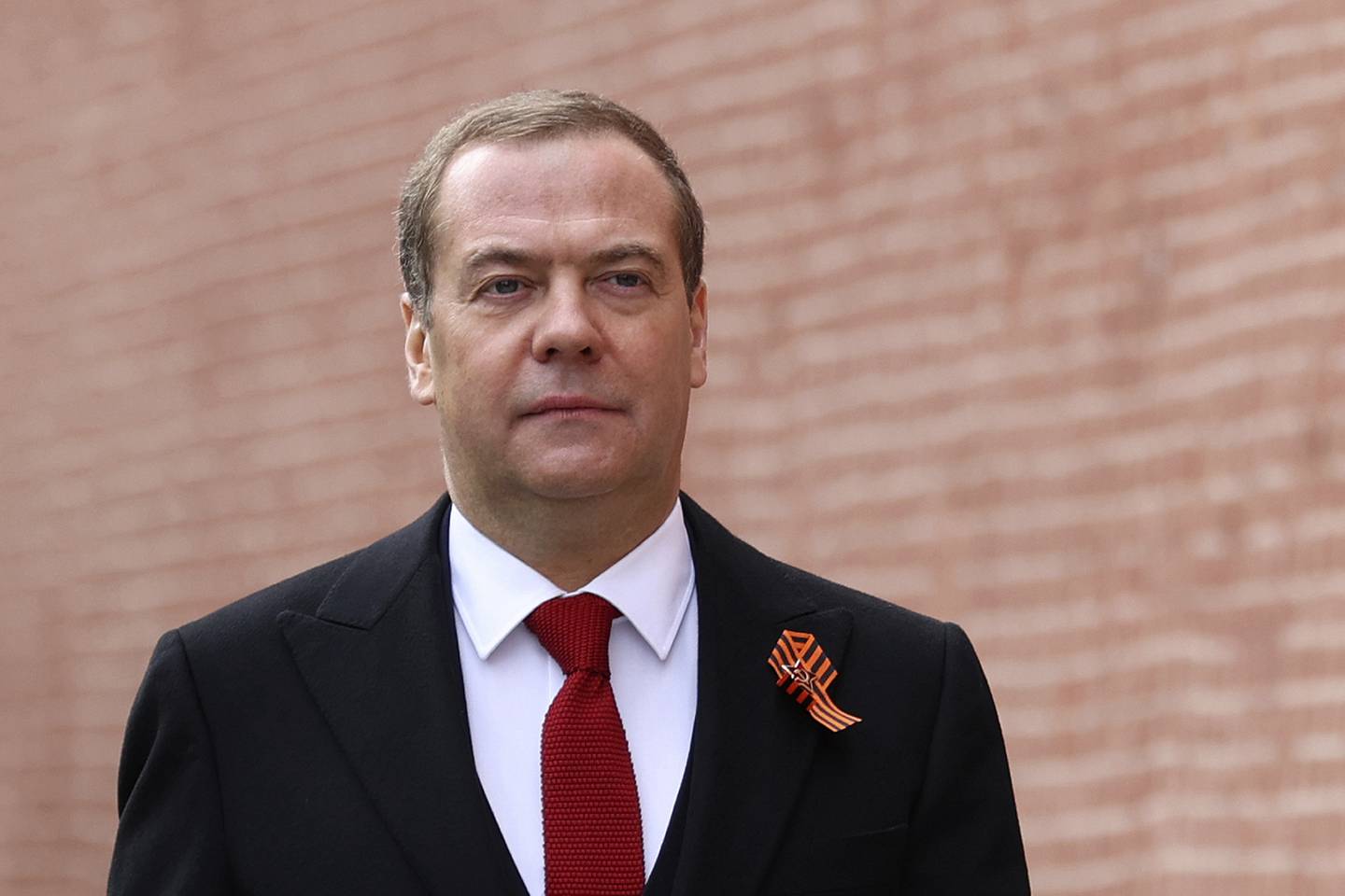 Deputy Head of Russia's Security Council Dmitry Medvedev arrives to attend a military parade on Victory Day, which marks the 77th anniversary of the victory over Nazi Germany in World War Two in Red Square in Moscow, Russia, Monday, May 9, 2022. Medvedev, the deputy head of Russia's Security Council chaired by President Vladimir Putin, said Thursday that growing Western arms supplies to Ukraine and training for its troops have "increased the probability that an ongoing proxy war will turn into an open and direct conflict between NATO and Russia." (Yekaterina Shtukina, Sputnik, Government Pool Photo via AP)