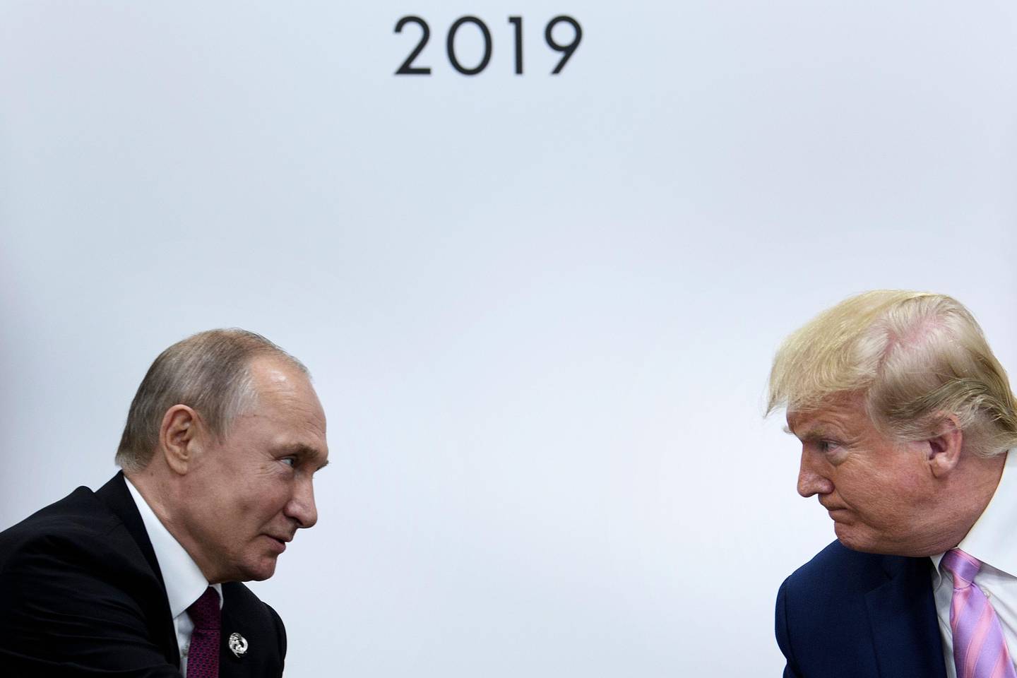 TOPSHOT - US President Donald Trump (R) attends a meeting with Russia's President Vladimir Putin during the G20 summit in Osaka on June 28, 2019. (Photo by Brendan Smialowski / AFP)