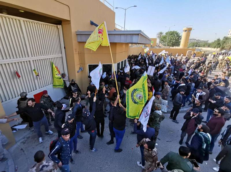 Protesters and militia fighters gather to condemn air strikes on bases belonging to Hashd al-Shaabi (paramilitary forces), outside the main gate of the U.S. Embassy in Baghdad, Iraq December 31, 2019. REUTERS/Thaier al-Sudani