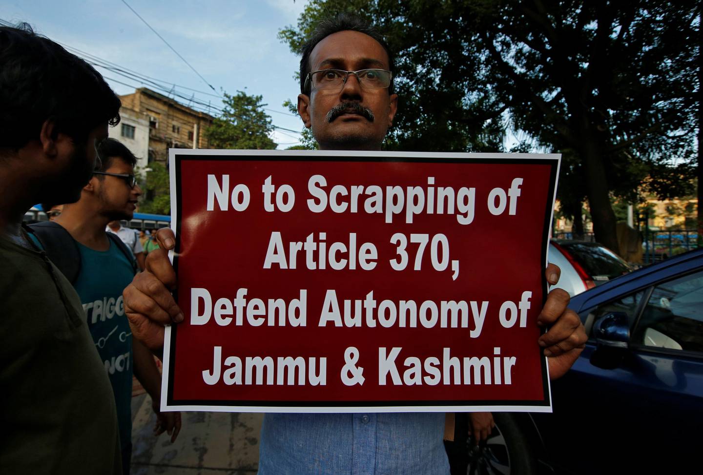 A man displays a placard during a protest against the scrapping of special constitutional status for Kashmir, in Kolkata, India, August 6, 2019. REUTERS/Rupak De Chowdhuri