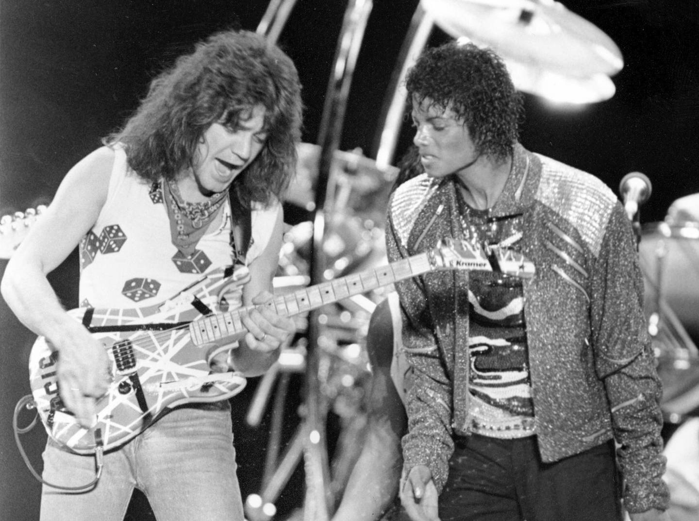 FILE - This July 14, 1984 file photo shows Van Halen guitarist Eddie Van Halen, left, performing "Beat It" with Michael Jackson during Jackson's Victory Tour concert in Irving, Texas. Van Halen, who had battled mouth cancer, died Tuesday, Oct. 6, 2020. He was 65. (AP Photo/Carlos Osorio, File)
