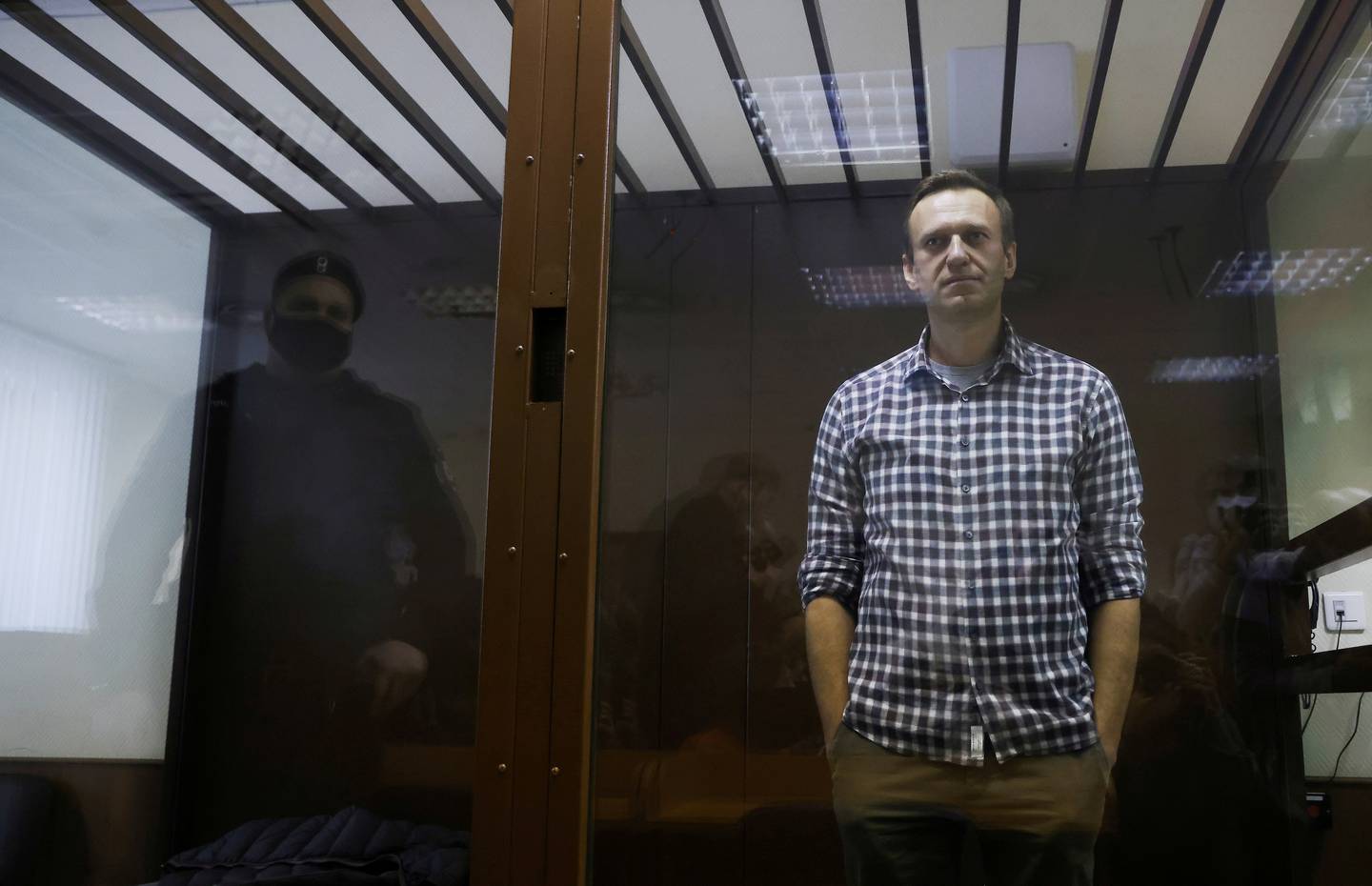 FILE PHOTO: Russian opposition leader Alexei Navalny attends a hearing to consider an appeal against an earlier court decision to change his suspended sentence to a real prison term, in Moscow, Russia February 20, 2021. REUTERS/Maxim Shemetov/File Photo