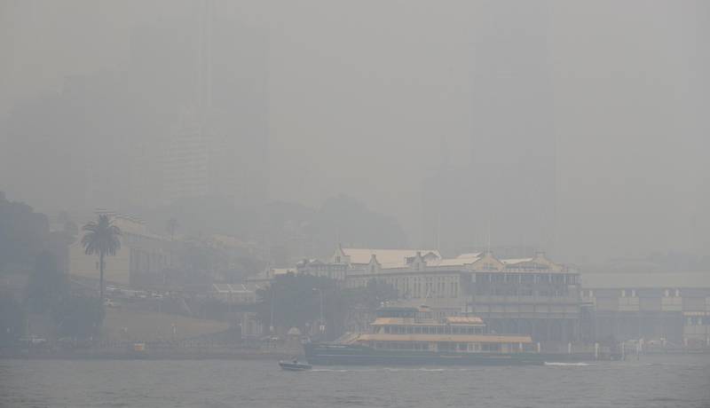A ferry sails on the harbor as thick smoke settles in Sydney, Australia, Tuesday, Dec. 10, 2019. Hot dry conditions have brought an early start to the fire season. (AP Photo/Rick Rycroft)