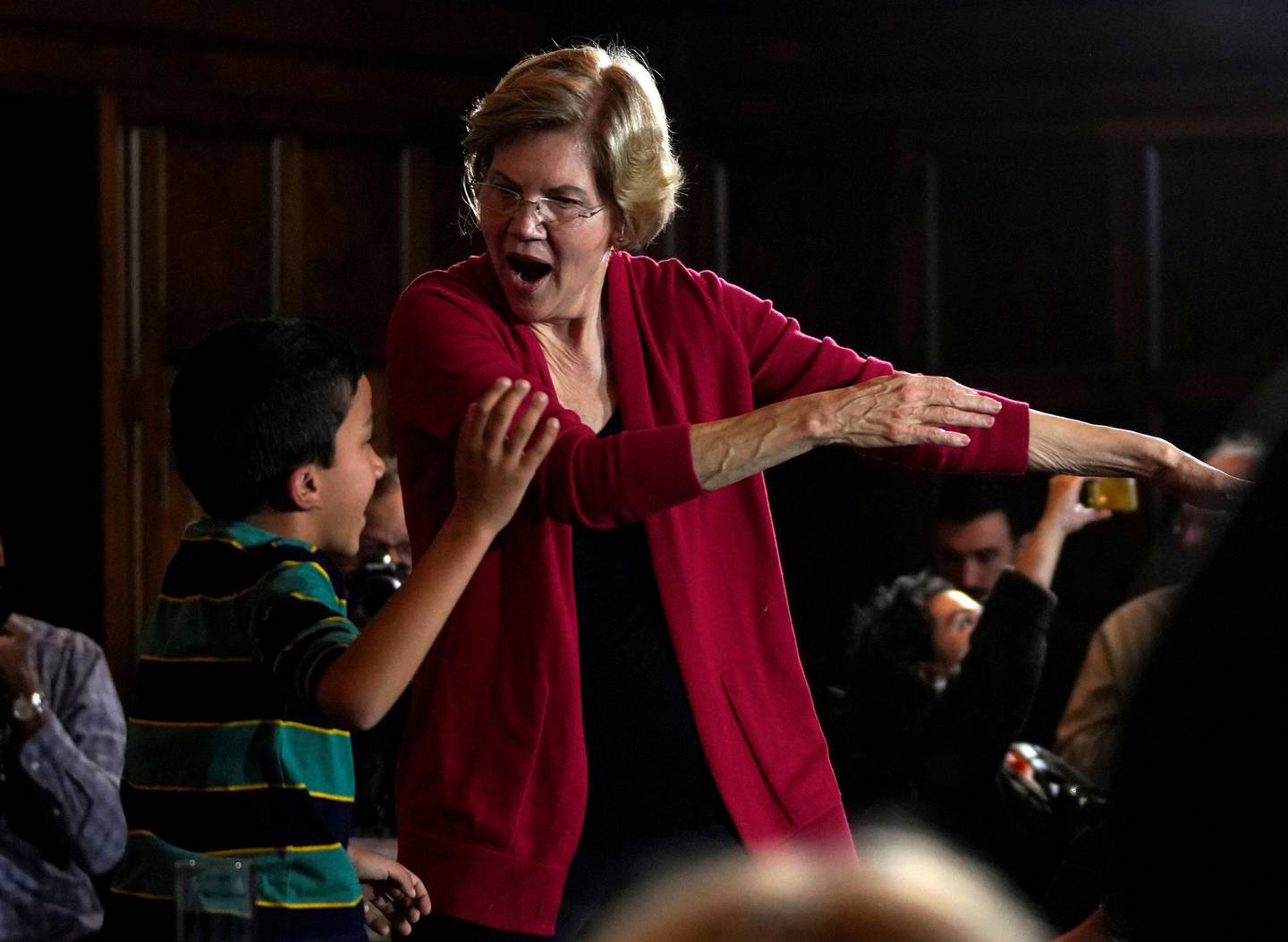 Democratic 2020 U.S. presidential candidate and U.S. Senator Elizabeth Warren (D-MA) dances with a boy at a campaign event in Ames, Iowa, U.S., February 2, 2020. REUTERS/Rick Wilking     TPX IMAGES OF THE DAY