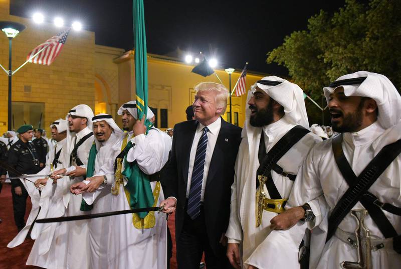 (FILES) In this file photo taken on May 20, 2017, US President Donald Trump joins Saudi Arabia's King Salman bin Abdulaziz al-Saud (3rd L) and other dancers with swords at a welcome ceremony ahead of a banquet at the Murabba Palace in the Saudi capital Riyadh. - Brandishing a sword and dancing to traditional music on his first visit to Saudi Arabia soon after taking office, Donald Trump launched a dramatic relationship revamp that freed the hands of the Gulf monarchies. More than three years on, regional leaders are playing their diplomatic cards in support of an erratic but valuable partner in Washington as he seeks a second term - one that would likely lead to even deeper tensions with Iran and more opportunities for their one-time enemy, Israel. (Photo by MANDEL NGAN / AFP)