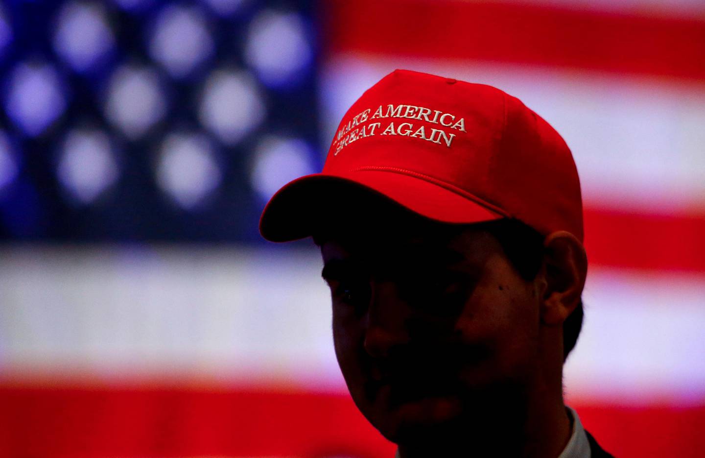 Oliver Lester, of Montgomery, wears a hat with President President Donald Trump's campaign slogan as he watches results come in for Gov. Kay Ivey at a watch party, Tuesday, Nov. 6, 2018, in Montgomery, Ala. (AP Photo/Butch Dill)