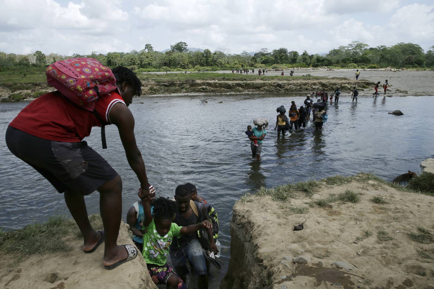 Migranter krysser elven Tuquesa i Panama etter å ha vandret i dagesvis gjennom jungelen.