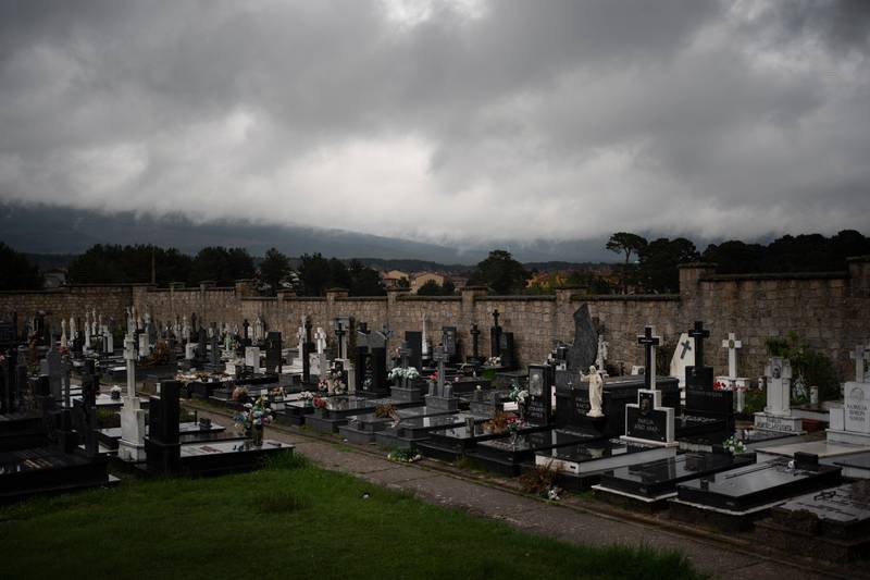In this April 28, 2020 photo, dark clouds cover the sky over the cemetery in Duruelo de la Sierra, Spain, in the province of Soria. Many in Spain's small and shrinking villages thought their low populations would protect them from the coronavirus pandemic. The opposite appears to have proved true. Soria, a north-central province that's one of the least densely peopled places in Europe, has recorded a shocking death rate. Provincial authorities calculate that at least 500 people have died since the start of the outbreak in April.(AP Photo/Felipe Dana)