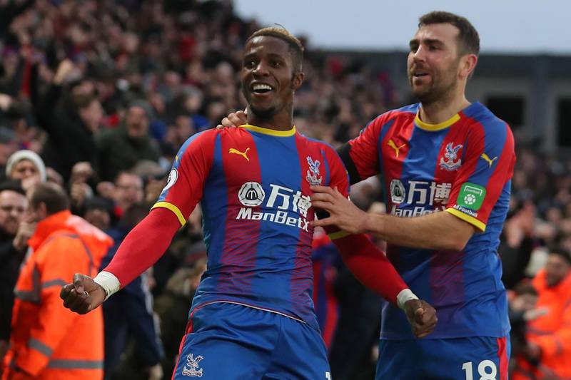 Crystal Palace's Ivorian striker Wilfried Zaha (L) celebrates with Crystal Palace's Scottish midfielder James McArthur (R) after scoring their first goal during the English Premier League football match between Crystal Palace and West Ham United at Selhurst Park in south London on February 9, 2019. (Photo by Daniel LEAL-OLIVAS / AFP) / RESTRICTED TO EDITORIAL USE. No use with unauthorized audio, video, data, fixture lists, club/league logos or 'live' services. Online in-match use limited to 120 images. An additional 40 images may be used in extra time. No video emulation. Social media in-match use limited to 120 images. An additional 40 images may be used in extra time. No use in betting publications, games or single club/league/player publications. / 