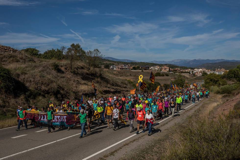 Catalan pro-independence demonstrators march near Navas, Spain, Wednesday, Oct. 16, 2019. Thousands of people have joined five large protest marches across Catalonia that are set to converge on Barcelona, as the restive region reels from two straight days of violent clashes between police and protesters. The marches set off from several Catalan towns and aimed to reach the Catalan capital by Friday. (AP Photo/Bernat Armangue)