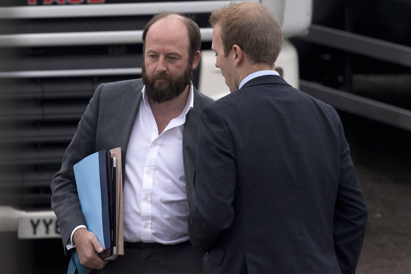 (FILES) This file photo taken on May 12, 2017 shows Joint Downing Street Chief of Staff, Nick Timothy (L), waiting at haulage and logistics company Davies Transport where British Prime Minister Theresa May is on a visit in north-east England.
One of British Prime Minister Theresa May's chief advisors announced his resignation Saturday, June 10, 2017, after a crushing electoral setback left her authority in tatters. Nick Timothy, one of two chiefs of staff on whom May relies heavily, said he took responsibility for the Conservative manifesto for Thursday's vote, in which the centre-right party lost its parliamentary majority.
 / AFP PHOTO / POOL / Justin TALLIS
