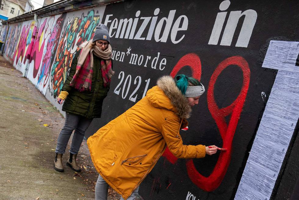 A photo taken on November 30, 2021 shows a woman repainting a wall commemorating the number of femicides in Austria in 2021 to 29 - referring to a woman killed at Vienna's Yppen Square - in Vienna. - Painted in blood red on an improvised memorial in Vienna, the number 31 is a stark reminder of a grim toll: the women killed by men in Austria last year. After several particularly horrific cases among the killings were widely reported in the media, the issue of femicide is now squarely under the spotlight. In a small, wealthy country where violent crime generally is rare, a public debate has begun, galvanising activists and forcing politicians to act. (Photo by ANDREA KLAMAR-HUTKOVA / AFP)