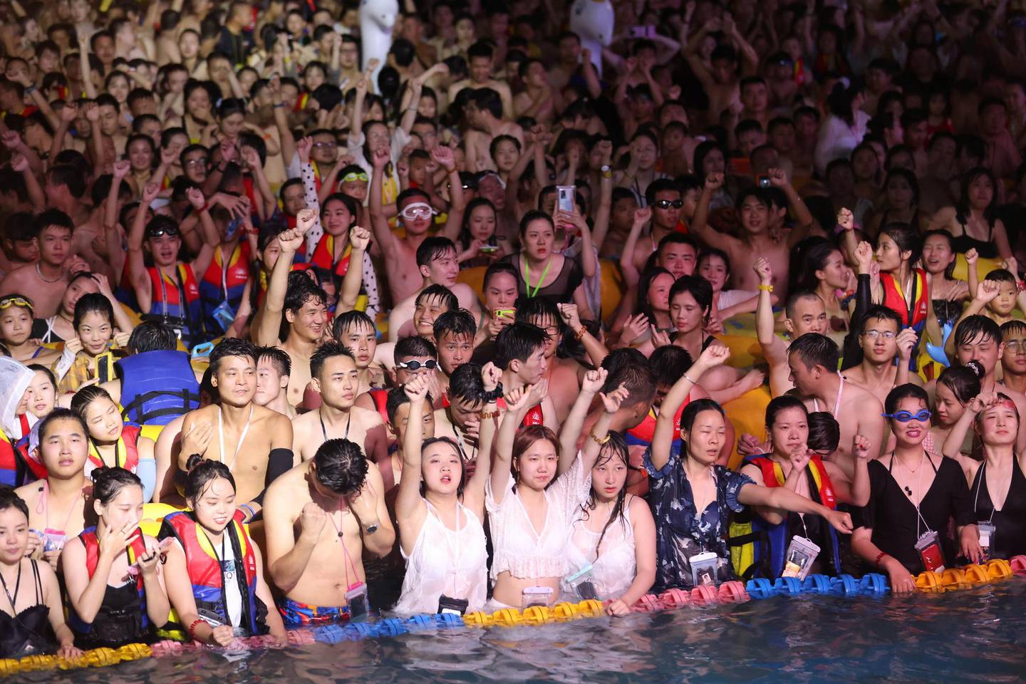 People enjoy a music party inside a swimming pool at the Wuhan Maya Beach Park, in Wuhan, following the coronavirus disease (COVID-19) outbreak, Hubei province, China August 15, 2020. Picture taken August 15, 2020. REUTERS/Stringer ATTENTION EDITORS - THIS IMAGE WAS PROVIDED BY A THIRD PARTY. CHINA OUT.