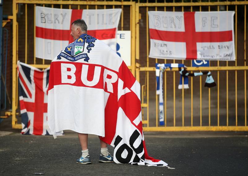 Soccer Football - Bury FC - Gigg Lane, Bury, Britain - August 27, 2019   A Bury FC fan wears a flag outside the stadium   Action Images via Reuters/Carl Recine       TPX IMAGES OF THE DAY